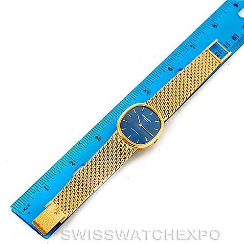 The image shows a top-down view of a Patek Philippe Golden Ellipse 3848 Men's Yellow Gold Blue Dial 3848 Men's Yellow Gold Blue Dial watch, placed next to a blue ruler for scale.