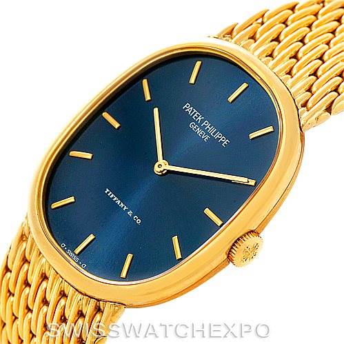 The image shows a Patek Philippe Golden Ellipse 3848 Men's Yellow Gold Blue Dial 3848 Men's Yellow Gold Blue Dial watch at an angle, highlighting its blue dial, golden case, and woven bracelet.
