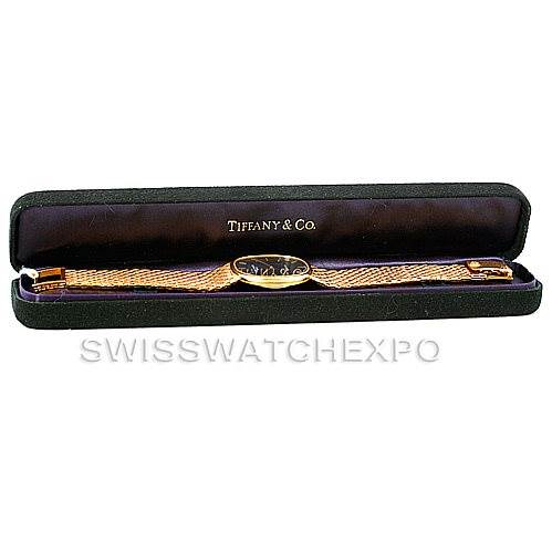 The Patek Philippe Golden Ellipse 3848 Men's Yellow Gold Blue Dial 3848 Men's Yellow Gold Blue Dial watch is shown lying flat in a Tiffany & Co. case with its face and bracelet visible.