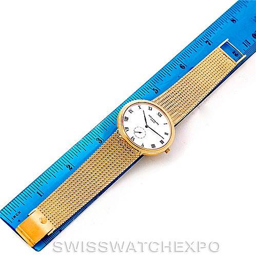 This image shows a top view of a Patek Philippe Calatrava 3919 Men's Yellow Gold White Dial 3919 Men's Yellow Gold White Dial watch, including the face, bezel, and part of the mesh strap.