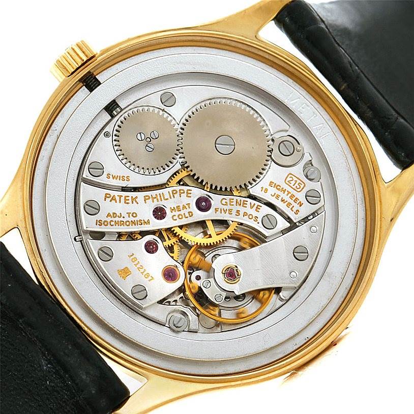 The image shows the back view of the Patek Philippe Calatrava 3923 Men's Yellow Gold Silver Dial 3923 Men's Yellow Gold Silver Dial model, exposing its intricate mechanical movement and components.