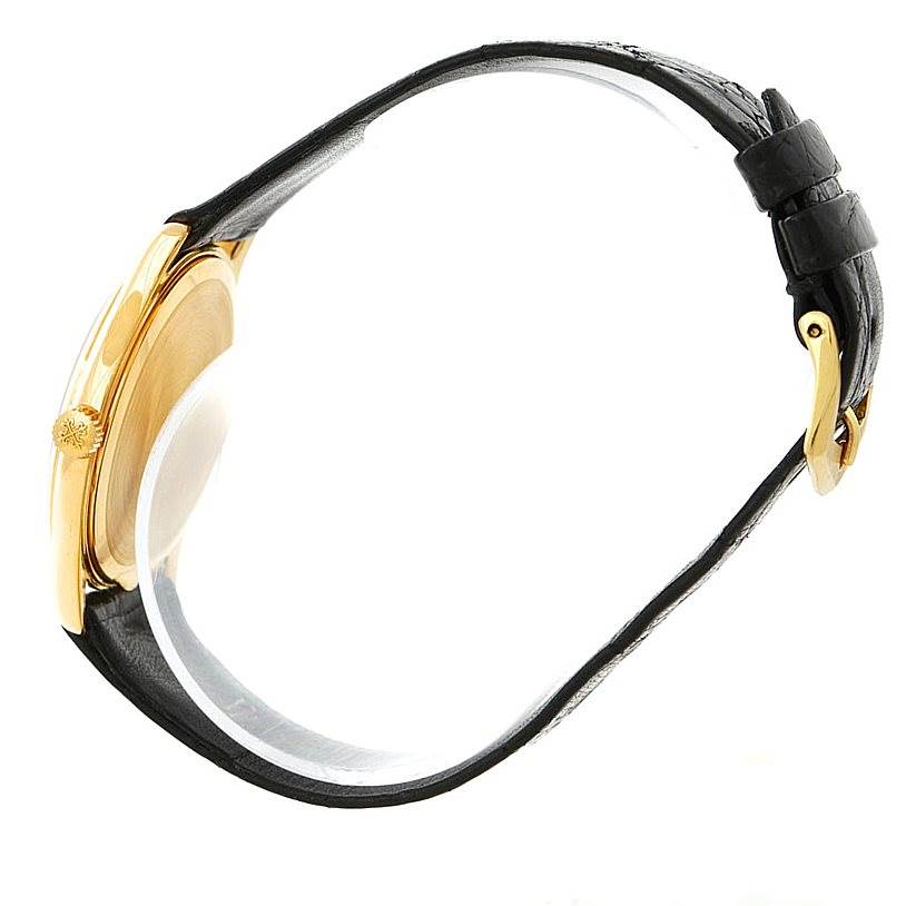 The image shows a side view of the Patek Philippe Calatrava 3923 Men's Yellow Gold Silver Dial 3923 Men's Yellow Gold Silver Dial watch, highlighting the crown, case, and black leather strap with a buckle.