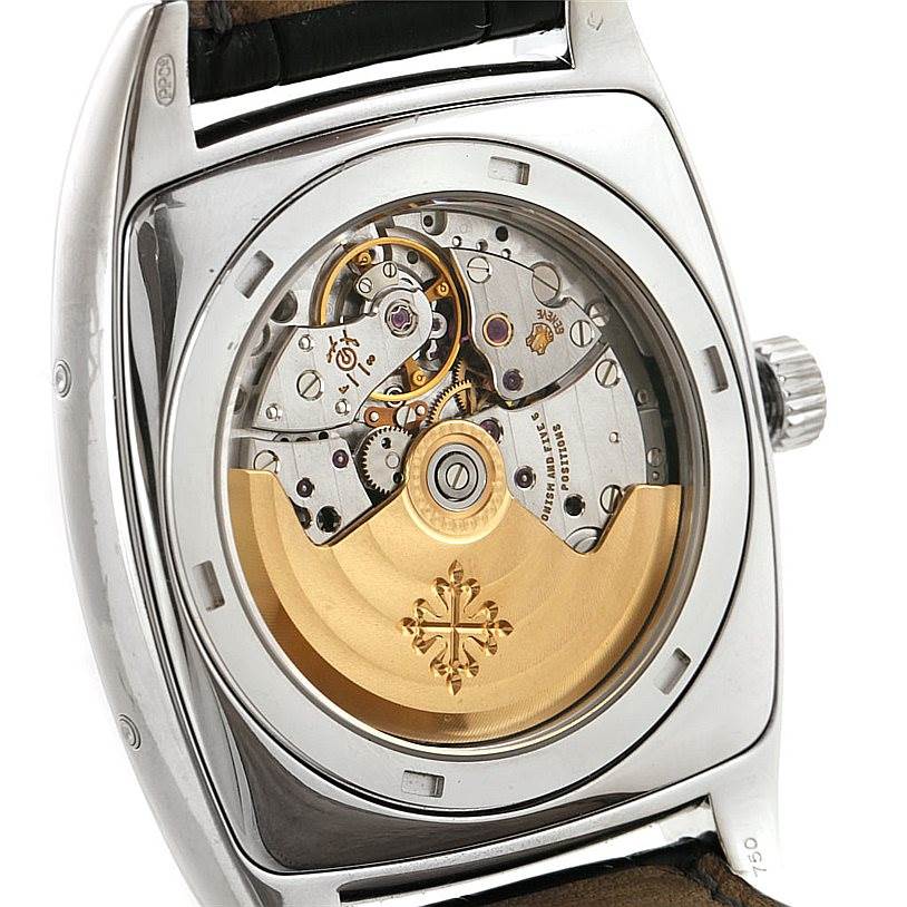 The image shows the back view of the Patek Philippe 5135G White Gold Silver Dial 5135G White Gold Silver Dial Gondolo Calendario 18K White Gold Watch 5135G, highlighting its intricate movement.