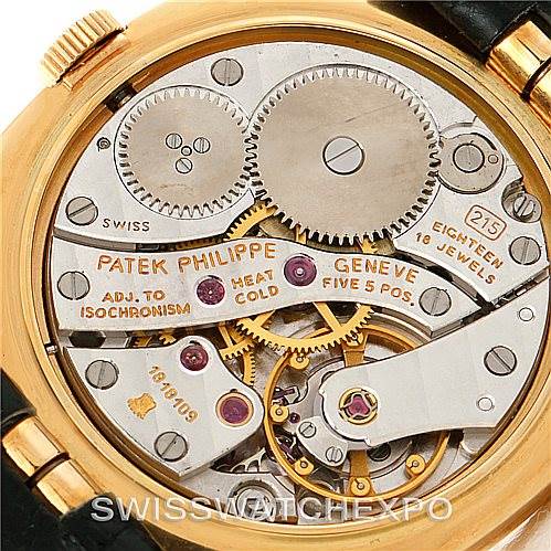 The image shows the movement of a Patek Philippe Golden Ellipse 3948 Men's Yellow Gold White Dial 3948 Men's Yellow Gold White Dial watch from a back angle, highlighting its intricate mechanical parts.