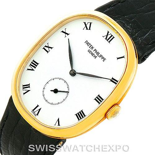 This image displays a Patek Philippe Golden Ellipse 3948 Men's Yellow Gold White Dial 3948 Men's Yellow Gold White Dial watch from an angle showing the face, gold casing, crown, and part of the black leather strap.