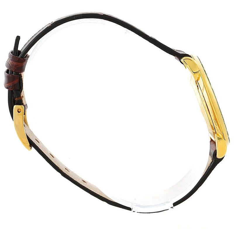 This image shows a side profile view of a Vintage Patek Philippe watch, featuring its gold case and leather strap.