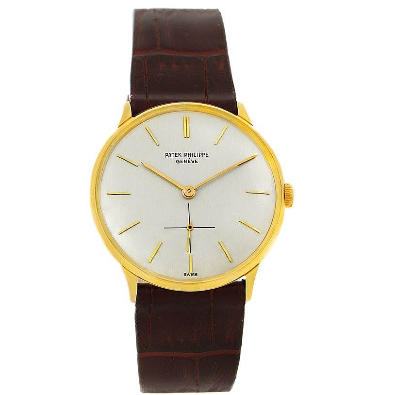 The image shows a front view of a Vintage Patek Philippe watch featuring a gold case and a brown leather strap.