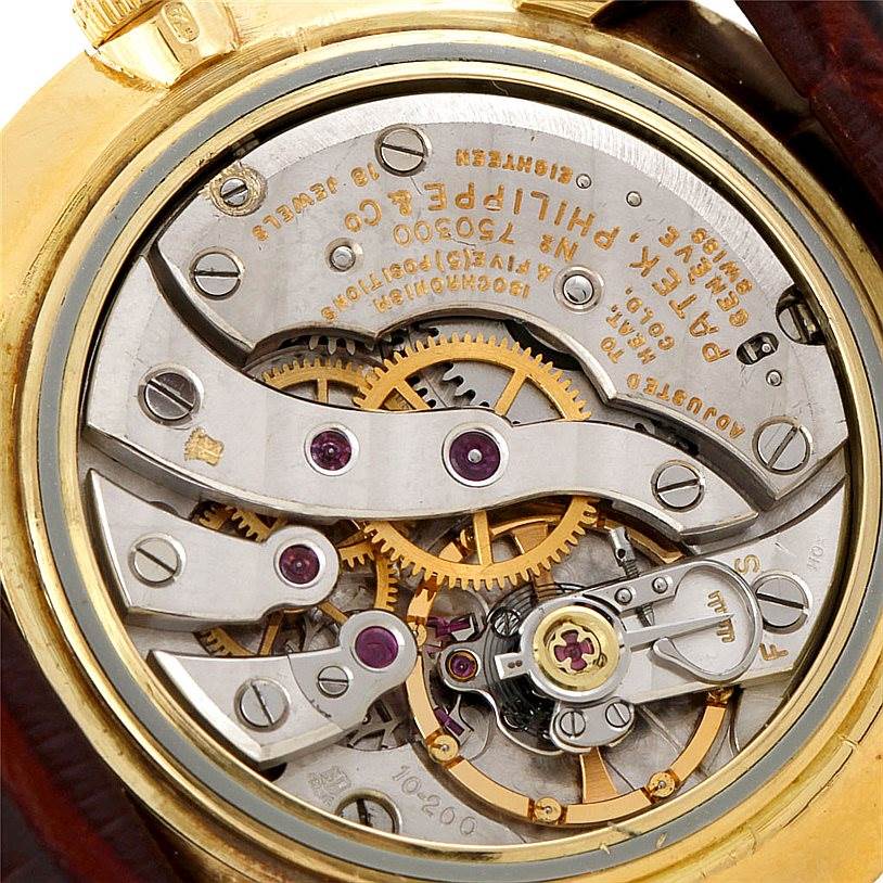 This close-up image shows the internal mechanical components of a Vintage Patek Philippe watch, viewed from the back.