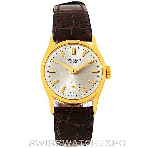 This image shows a front-facing view of a Vintage Patek Philippe watch with a gold case, a white dial, gold hour markers, and a brown leather strap.
