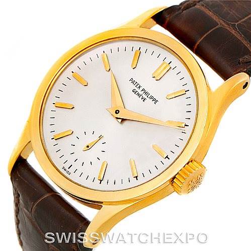 The image shows a Patek Philippe Vintage watch at a slight angle, highlighting the gold case, crown, white dial, and brown leather strap.