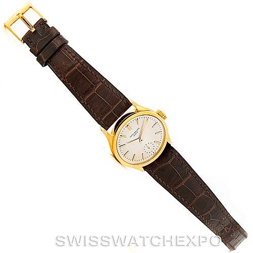 This image shows a bird
s-eye view of a Vintage Patek Philippe watch, displaying its dial, bezel, leather strap, and buckle.