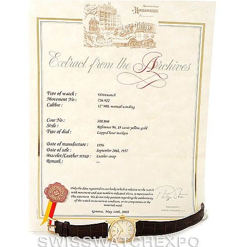 The image shows a Vintage Patek Philippe watch laying flat with its accompanying archive certificate in the background.