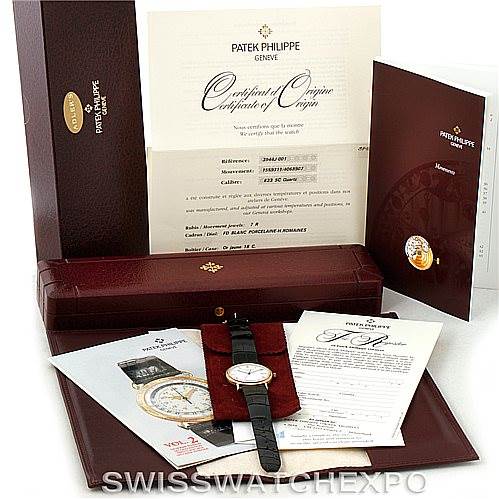 The image shows a Patek Philippe Calatrava 3944 Men's Yellow Gold White Dial 3944 Men's Yellow Gold White Dial watch at a slightly elevated angle, along with its box, certificates, and booklets.