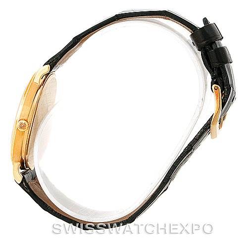 The image shows a side view of a Patek Philippe Calatrava 3944 Men's Yellow Gold White Dial 3944 Men's Yellow Gold White Dial watch, highlighting the case, crown, and leather strap with a buckle.