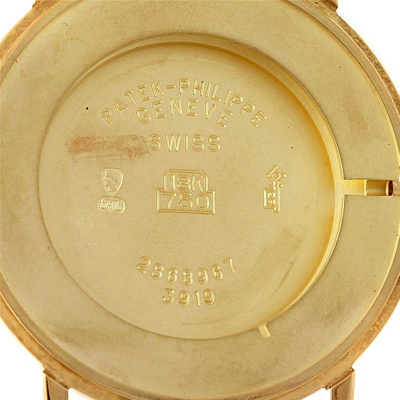 The image shows the interior back cover of a Patek Philippe Calatrava 3919 Men's Yellow Gold White Dial 3919 Men's Yellow Gold White Dial watch, with engravings indicating specifications.