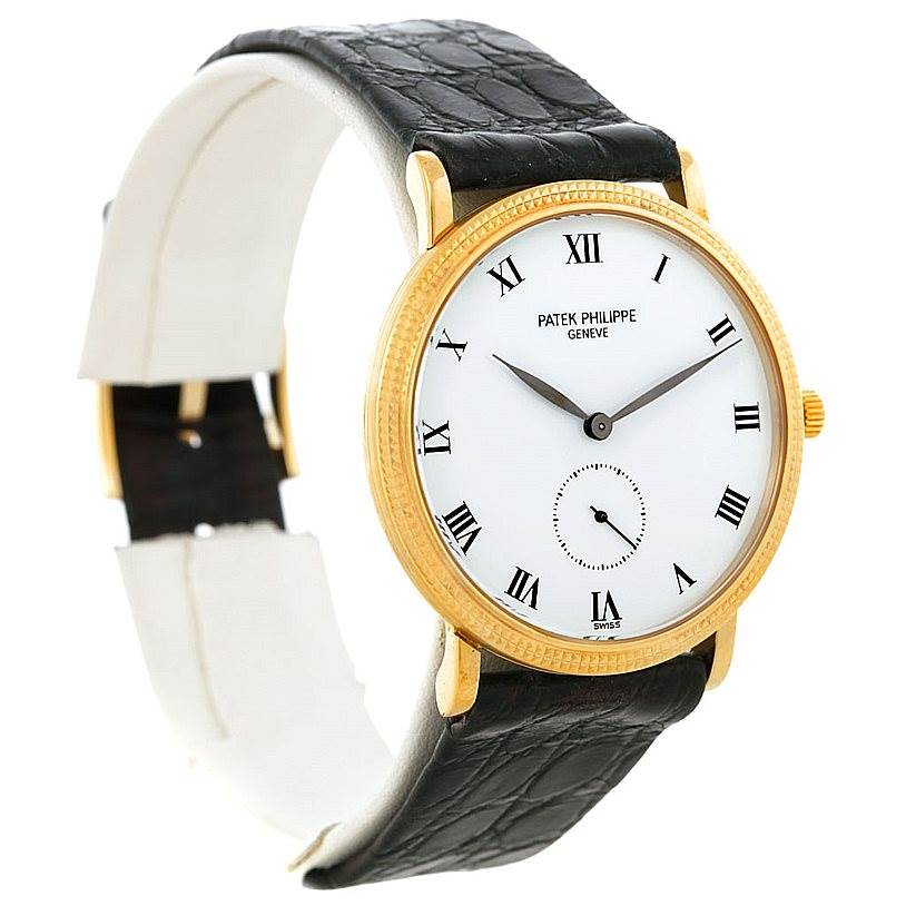 The image shows a side-angle view of a Patek Philippe Calatrava 3919 Men's Yellow Gold White Dial 3919 Men's Yellow Gold White Dial watch, highlighting its white dial, Roman numerals, gold casing, and black leather strap.