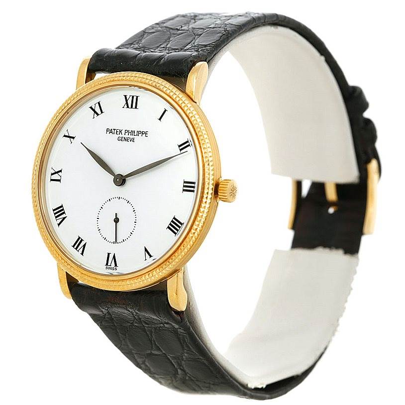 This image shows the Patek Philippe Calatrava 3919 Men's Yellow Gold White Dial 3919 Men's Yellow Gold White Dial watch angled from the front, highlighting its face, bezel, and strap.