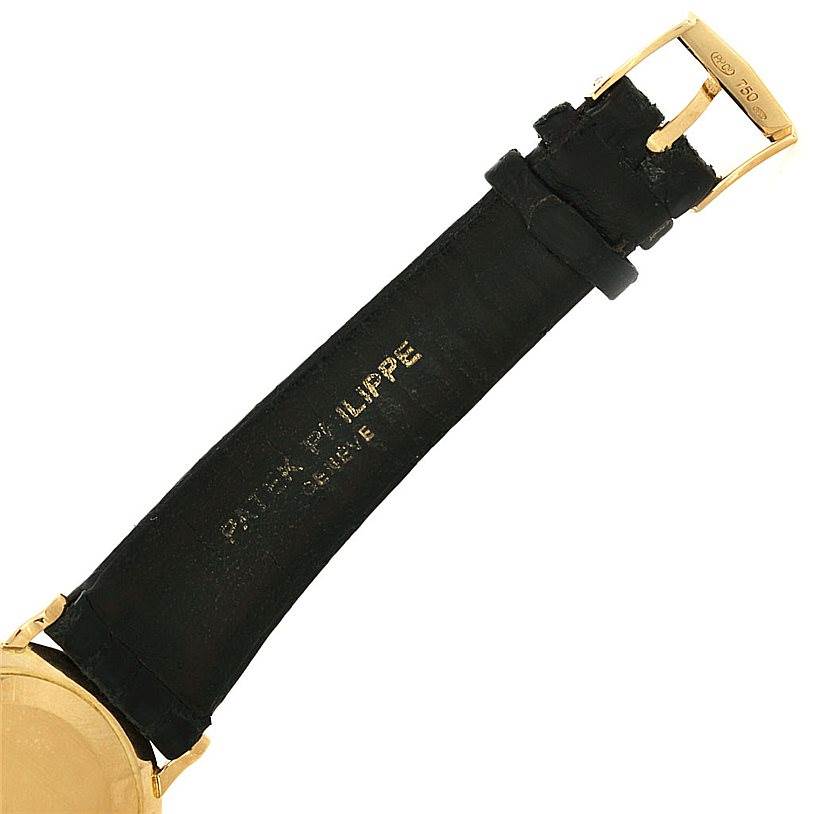 This image shows the gold buckle and black leather strap of a Patek Philippe Calatrava 3919 Men's Yellow Gold White Dial 3919 Men's Yellow Gold White Dial watch.