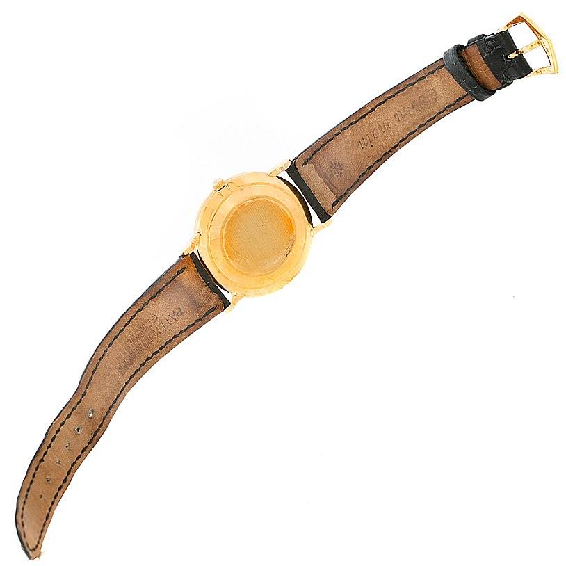 This image shows the back view of a Patek Philippe Calatrava 3919 Men's Yellow Gold White Dial 3919 Men's Yellow Gold White Dial watch with its brown leather strap fully extended.