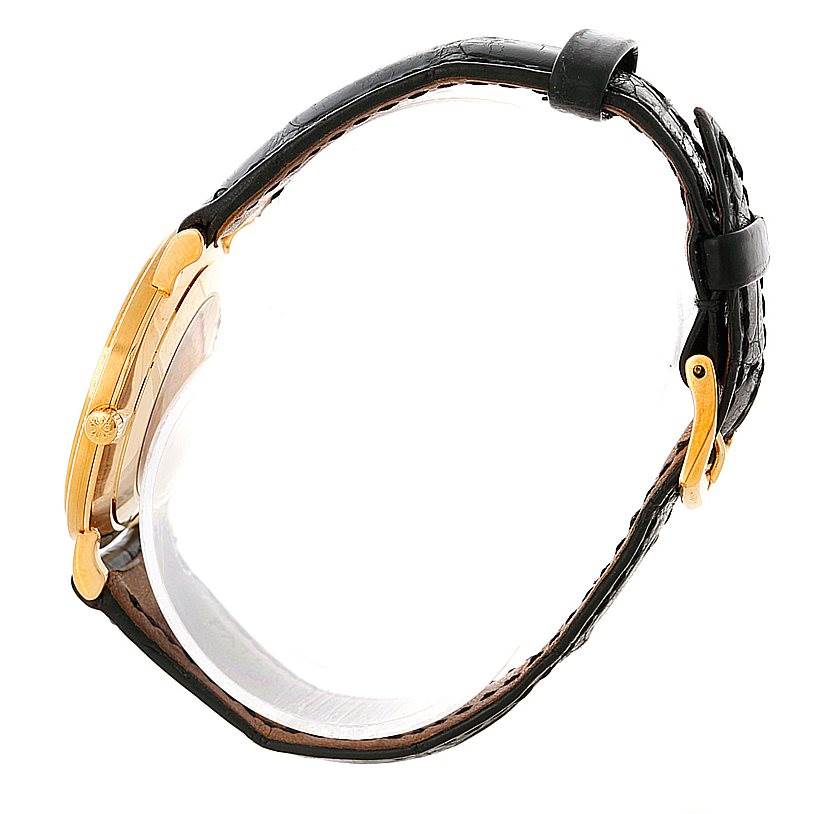 The image shows a side profile view of a Patek Philippe Calatrava 3919 Men's Yellow Gold White Dial 3919 Men's Yellow Gold White Dial watch highlighting its gold case, crown, and leather strap.