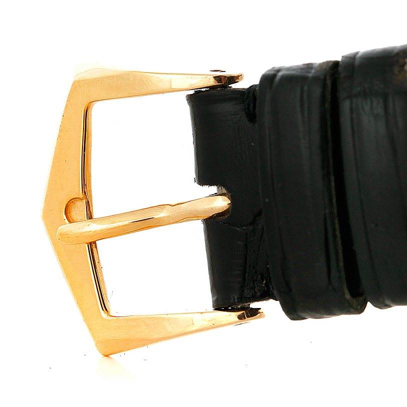The image shows a close-up of the gold buckle and black leather strap of a Vintage Patek Philippe watch.