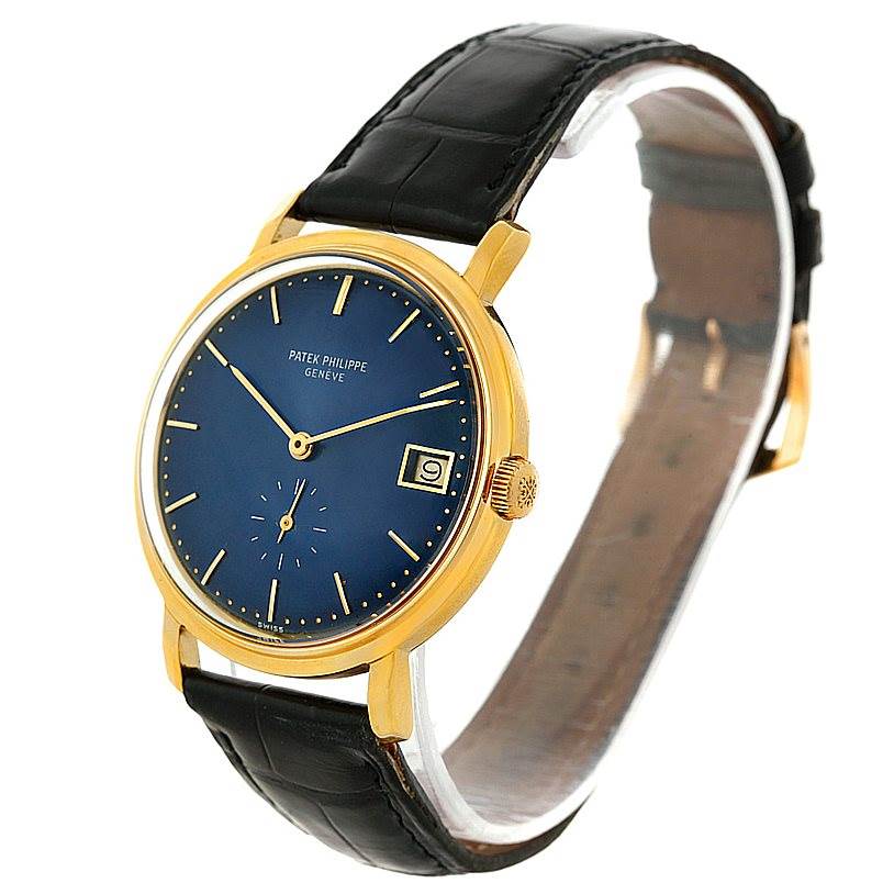 This image shows a Patek Philippe Vintage model at an angle showcasing its blue dial, gold case, and black leather strap.