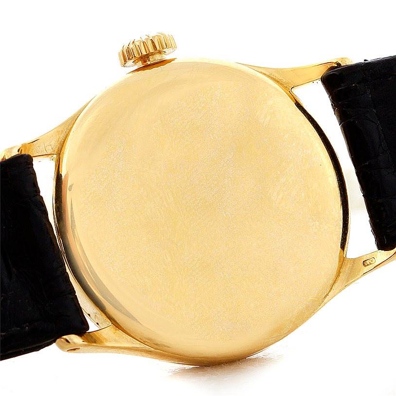 This image shows the back case and crown of a Vintage model Patek Philippe watch viewed from the rear.