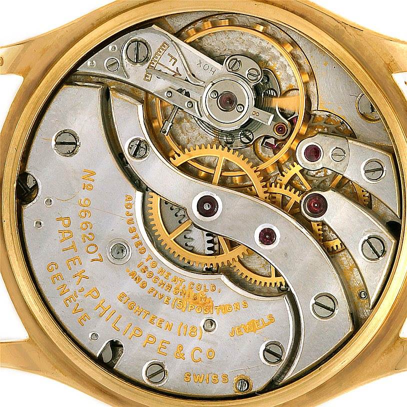 The image shows the intricate movement mechanism of a Patek Philippe Vintage watch from a back angle without the caseback.
