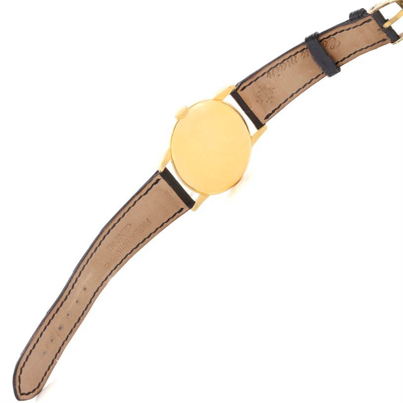 This image shows the back and band of the Vintage Patek Philippe watch, highlighting its gold case and leather strap.