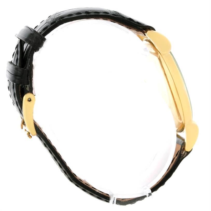 The image shows a side view of the Vintage Patek Philippe watch, highlighting the black leather strap and gold case.