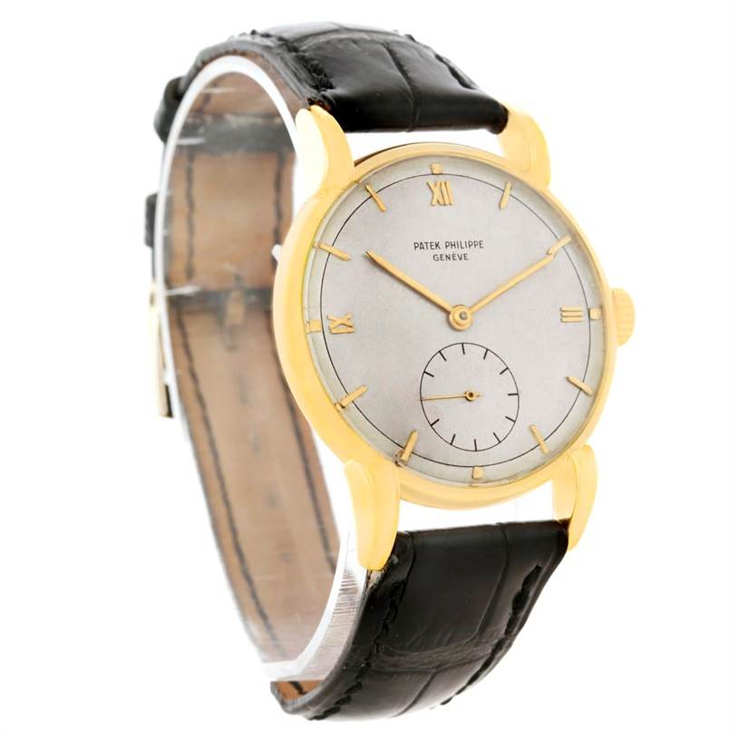 The image shows a side-front angle of a Vintage Patek Philippe watch displaying its face, leather strap, and gold case.
