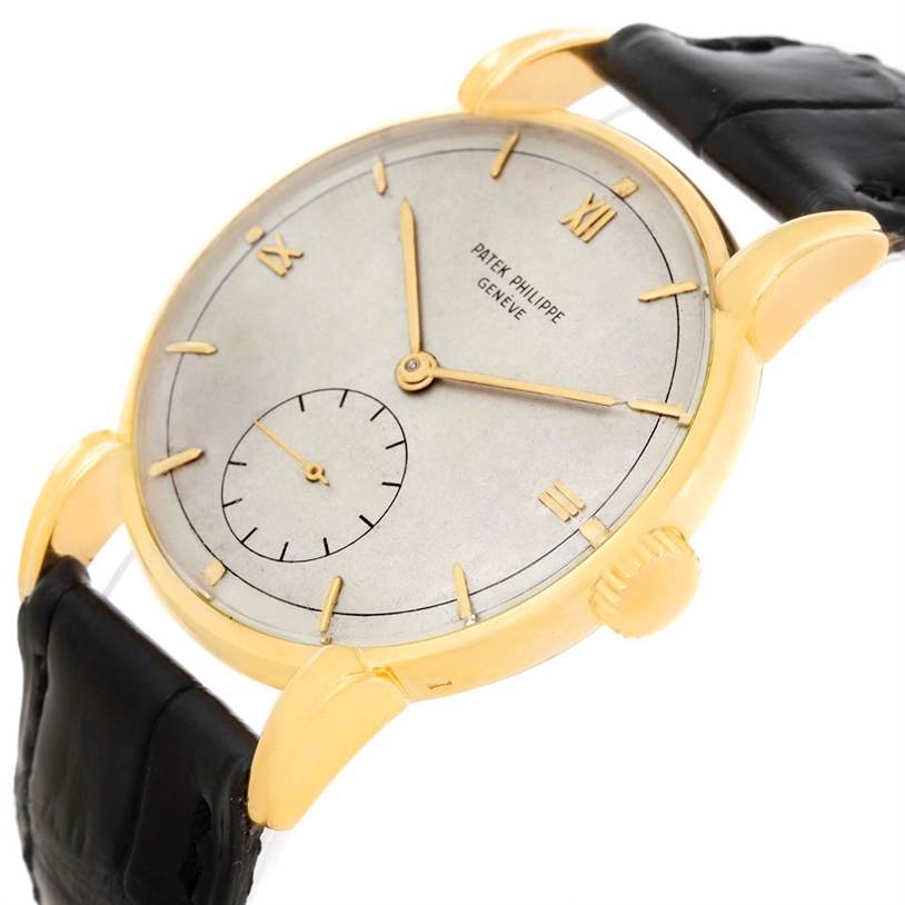 This image shows a Patek Philippe Vintage watch at an oblique angle, highlighting its dial, hands, case, lugs, and strap.