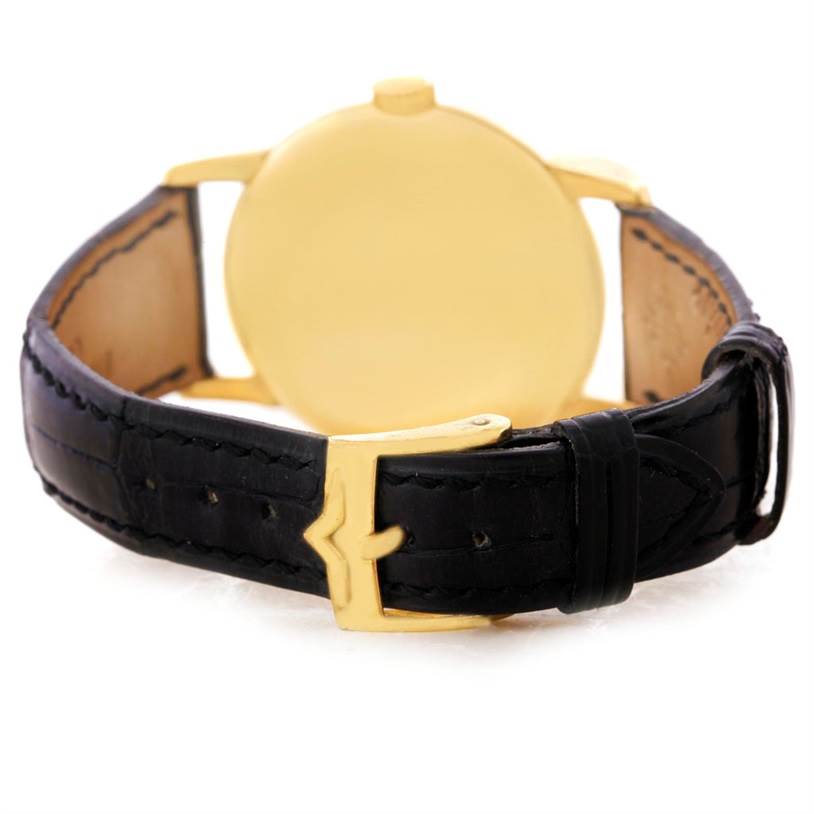 This image shows the back case and black leather strap of a Vintage Patek Philippe watch.