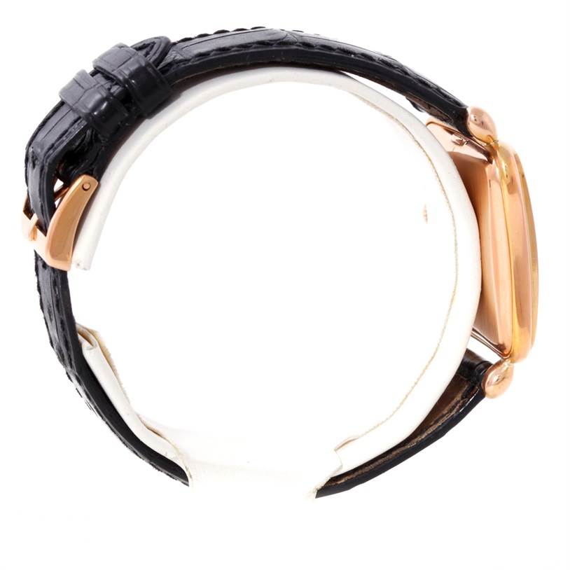 The image shows a side view of a Patek Philippe Calatrava 2493 Men's Rose Gold Silver Dial 2493 Men's Rose Gold Silver Dial watch, focusing on the black leather strap and gold case.