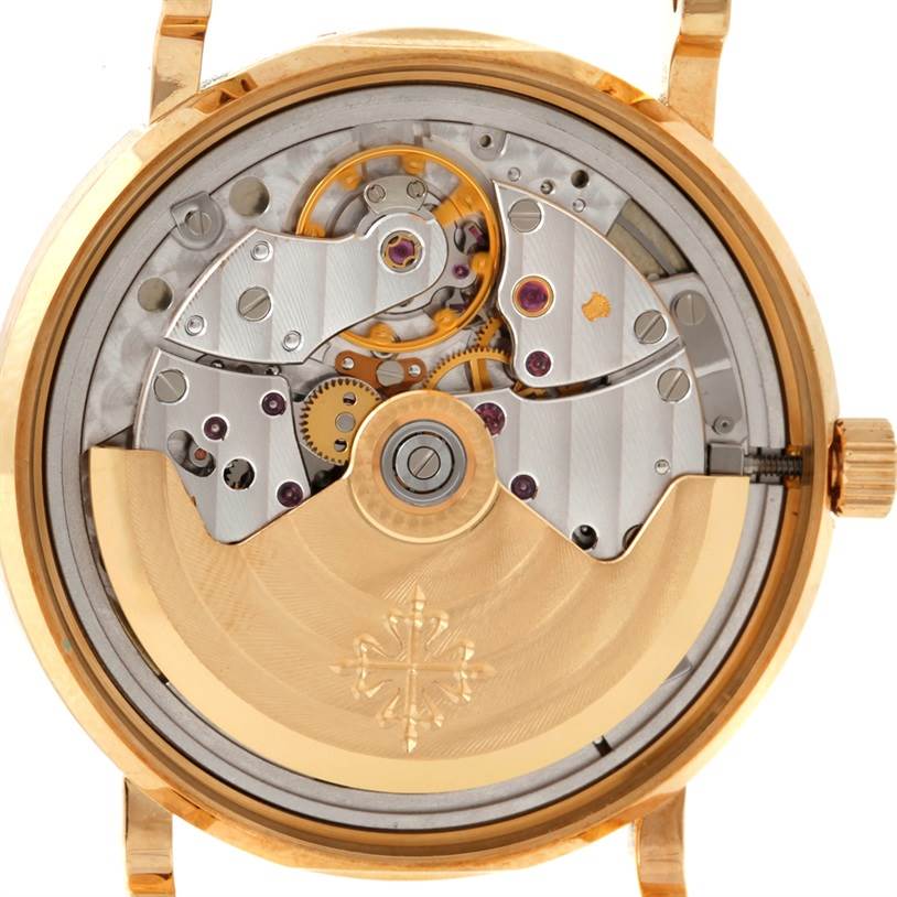 This image shows the back view of a Patek Philippe Calatrava 3802 Men's Yellow Gold White Dial 3802 Men's Yellow Gold White Dial watch, highlighting its intricate movement and rotor mechanism.