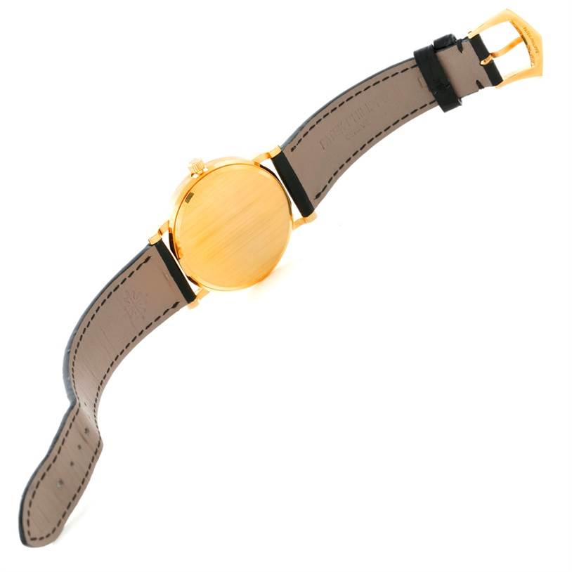 The image shows the back case and leather straps of a Patek Philippe Calatrava 3802 Men's Yellow Gold White Dial 3802 Men's Yellow Gold White Dial watch at an angled top-down view.