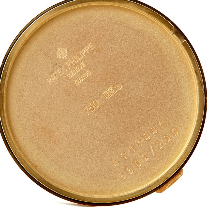 This image shows the inner case back of a Patek Philippe Calatrava 3802 Men's Yellow Gold White Dial 3802 Men's Yellow Gold White Dial watch, displaying engravings and hallmarks.