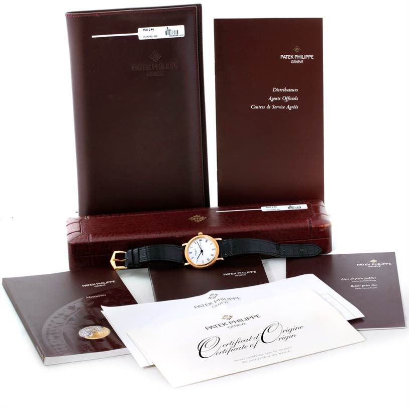 The image shows a Patek Philippe Calatrava 3802 Men's Yellow Gold White Dial 3802 Men's Yellow Gold White Dial watch along with its accessories, including documentation, a case, and booklets.