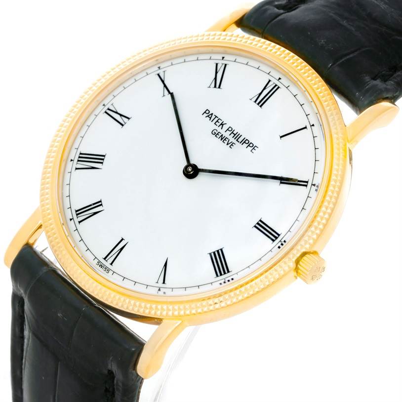 This image shows a Patek Philippe Calatrava 3520 Men's Yellow Gold White Dial 3520 Men's Yellow Gold White Dial watch at a slight angle, highlighting its white dial, black Roman numerals, and gold case with a black leather strap.