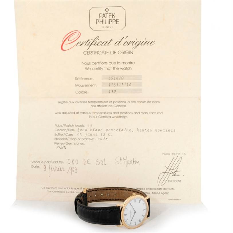 The image shows a Patek Philippe Calatrava 3520 Men's Yellow Gold White Dial 3520 Men's Yellow Gold White Dial watch at a slight side angle with its certificate of origin behind it.
