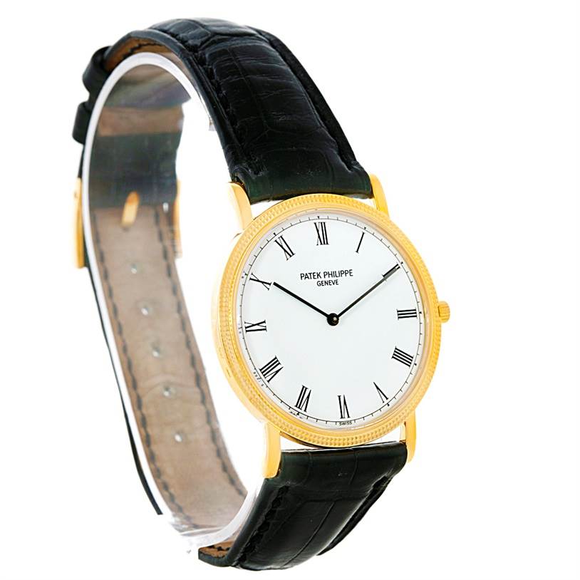 The image shows a Patek Philippe Calatrava 3520 Men's Yellow Gold White Dial 3520 Men's Yellow Gold White Dial watch at a slight angle, displaying its face, Roman numerals, bezel, and black leather strap.