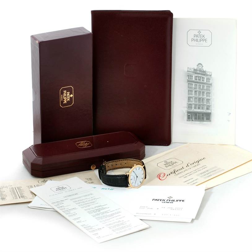 The image shows a Patek Philippe Calatrava 3520 Men's Yellow Gold White Dial 3520 Men's Yellow Gold White Dial watch, its box, papers, and related accessories from a top-down angle.