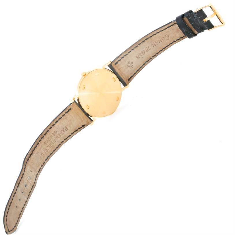 The image shows the back view of a Patek Philippe Calatrava 3520 Men's Yellow Gold White Dial 3520 Men's Yellow Gold White Dial watch, highlighting its case back and strap.