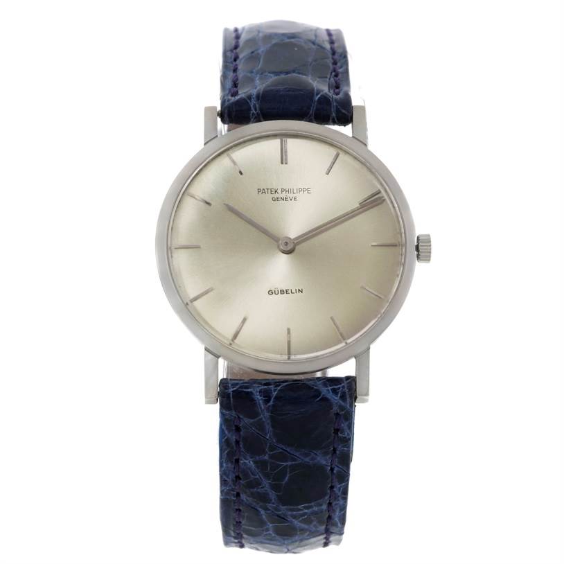 This image shows a frontal view of a Vintage Patek Philippe watch with a blue strap and a minimalist dial.