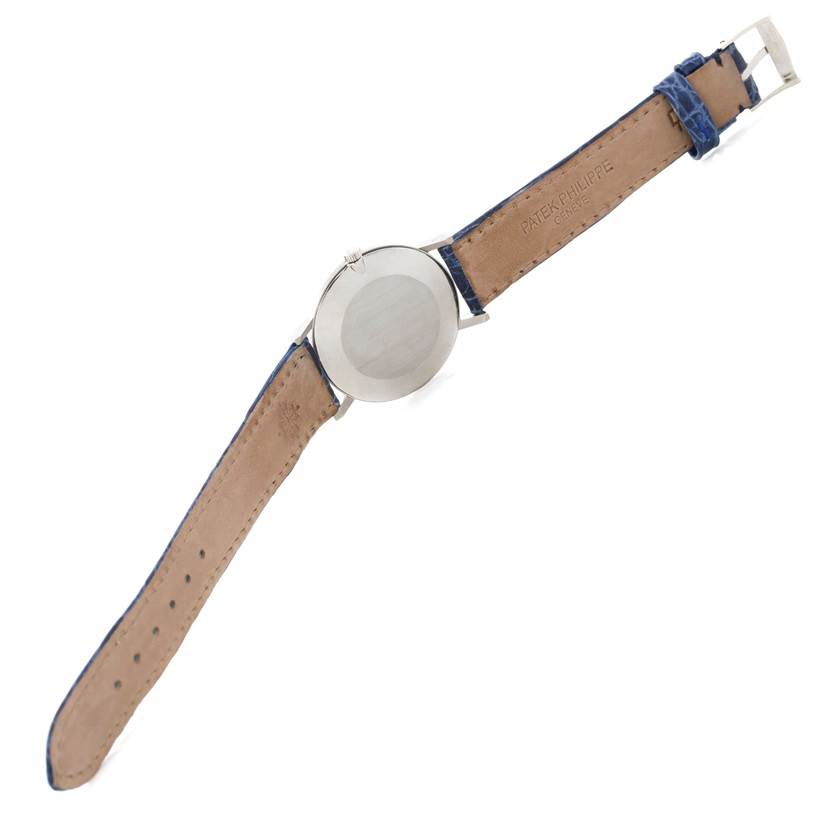 The image shows the back view of a Vintage Patek Philippe watch, displaying its case back and leather strap.