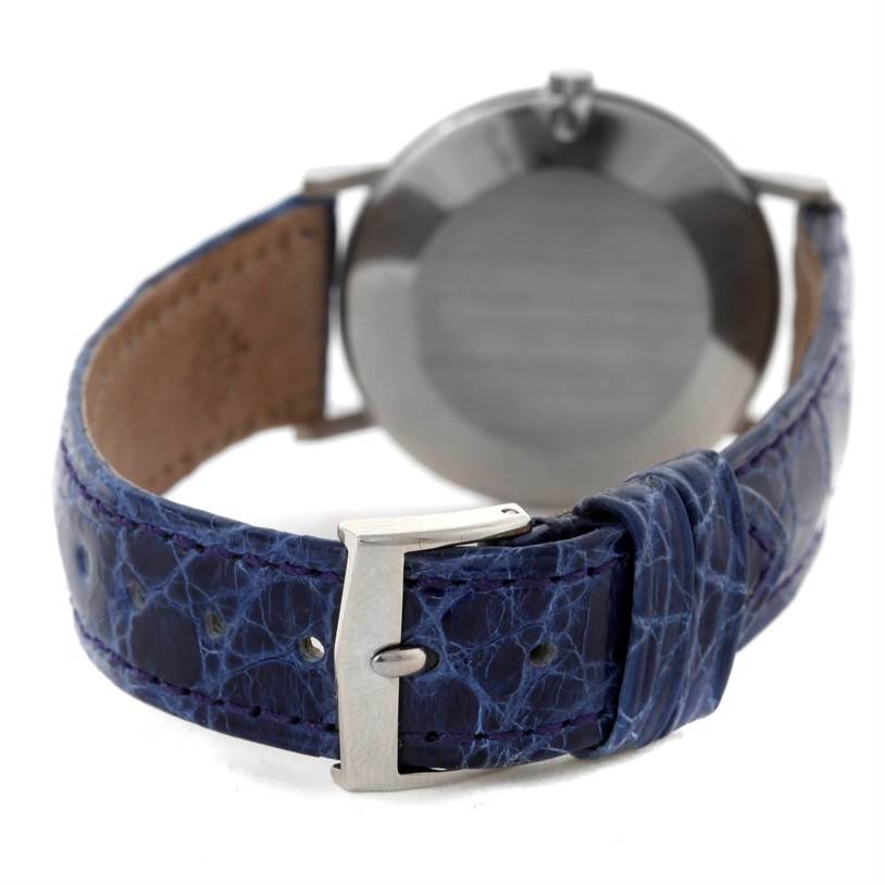 The image shows the back of a Vintage Patek Philippe watch and its blue leather strap with a metal buckle.