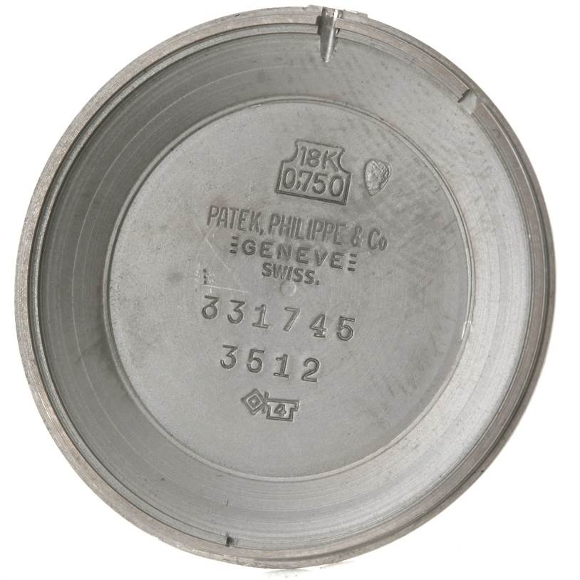 This image shows the inner case back of a Vintage Patek Philippe model 3512 watch, displaying inscriptions and hallmarks.