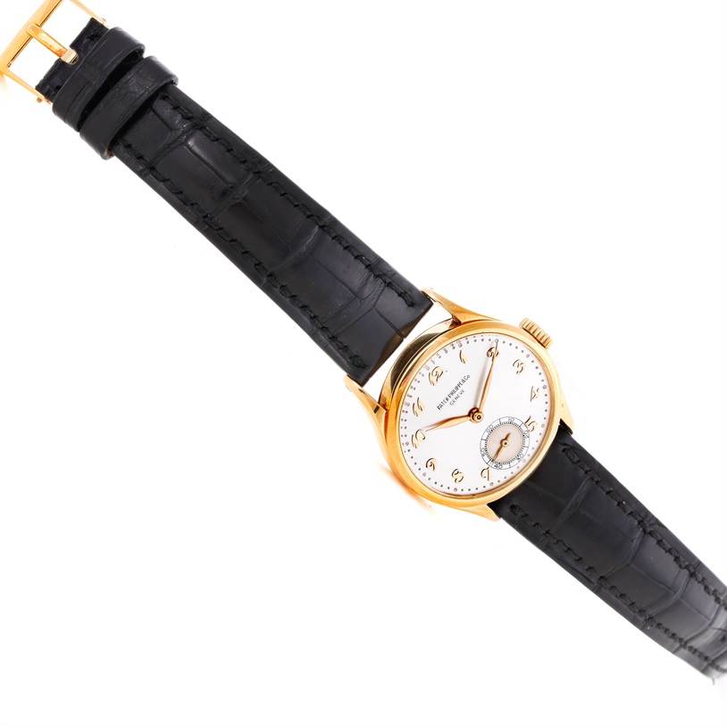 This image shows a Patek Philippe Vintage model watch at a tilted angle, displaying the dial, hands, and black leather strap.