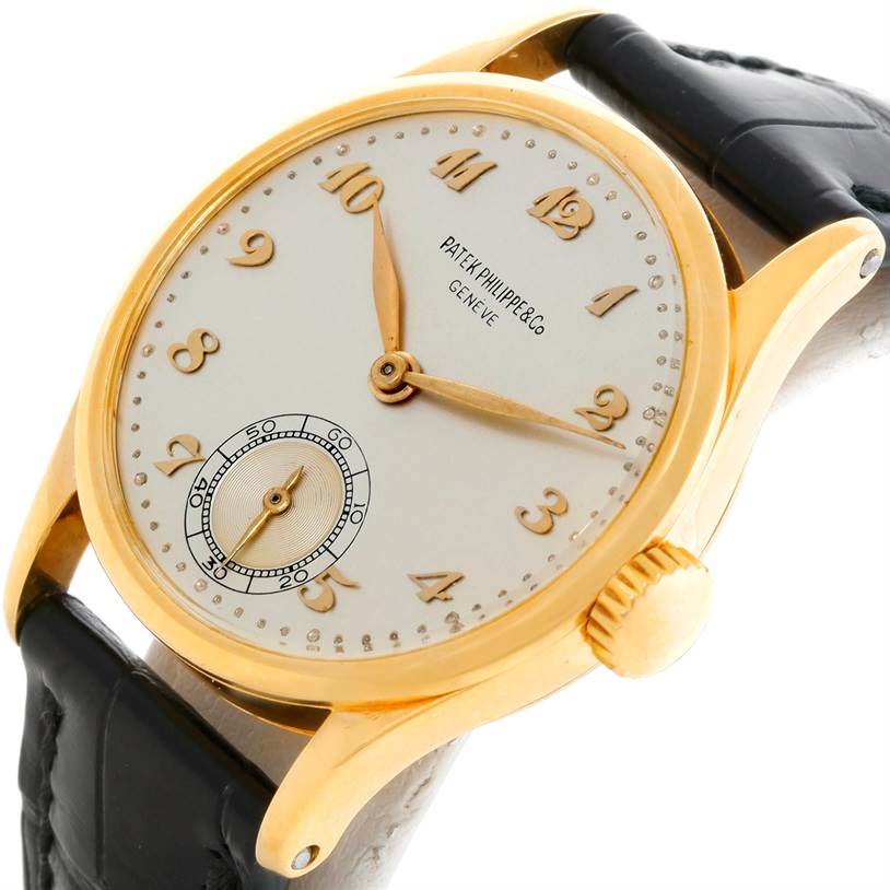 This is a close-up of a Vintage Patek Philippe watch showing the dial, hands, numbers, crown, and part of the strap.