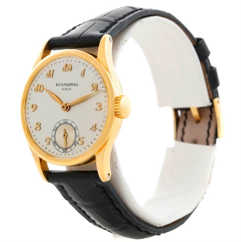 The image shows a side and front angle of a Vintage Patek Philippe watch with a white dial, gold case, and black leather strap.